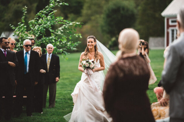 Bride walking down an outdoor wedding aisle
