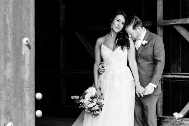 Black-and-white newlywed portrait in a doorway